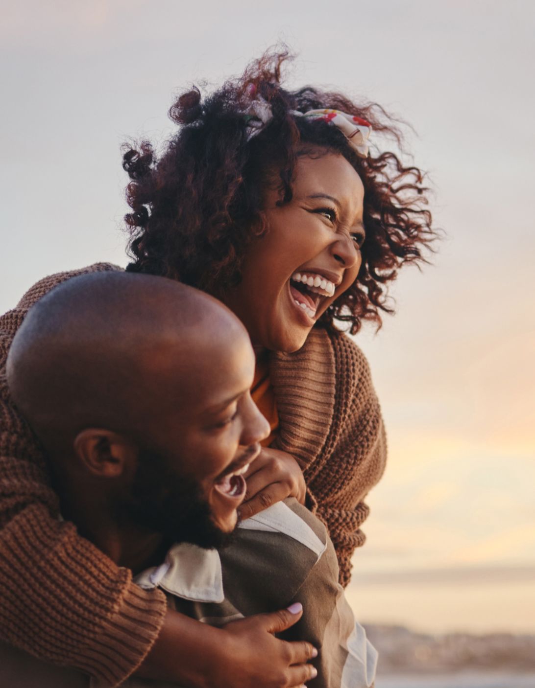 Couple laughing together at sunset