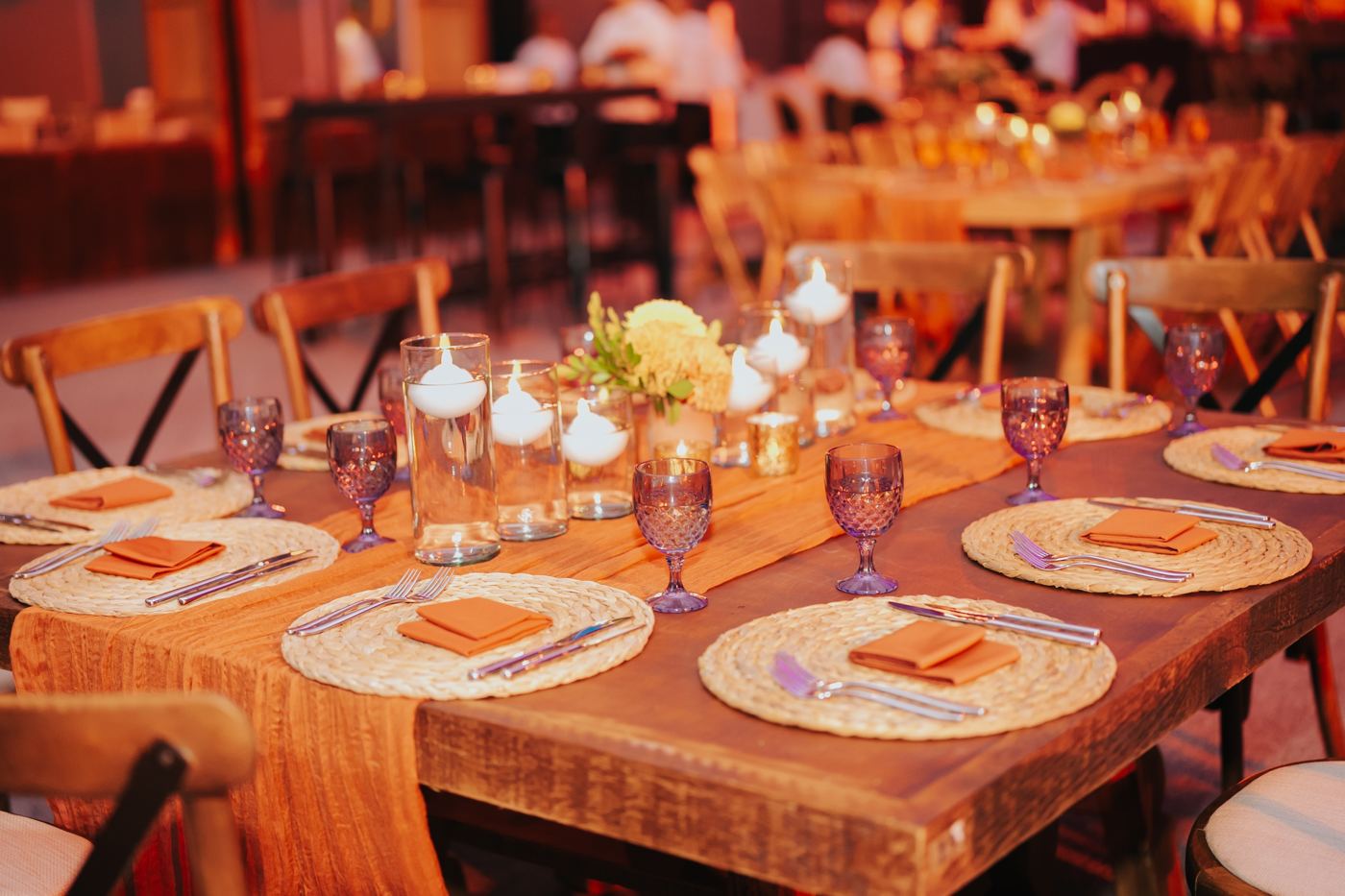 Candlelit reception table with terracotta napkins