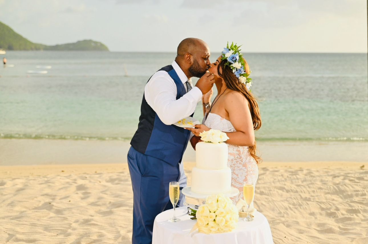 Couple cutting their wedding cake on the beach